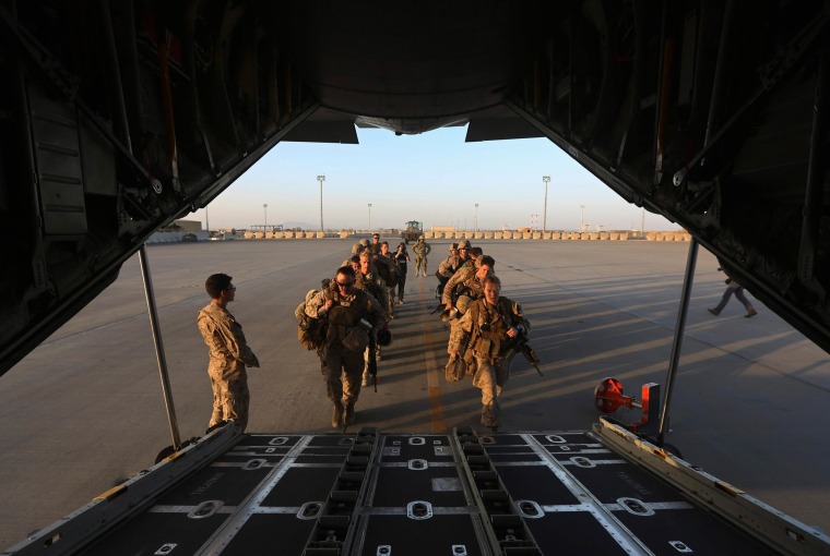 Image: U.S. Marines prepare to board a plane at the end of operations for U.S. Marines and British combat troops in Helmand