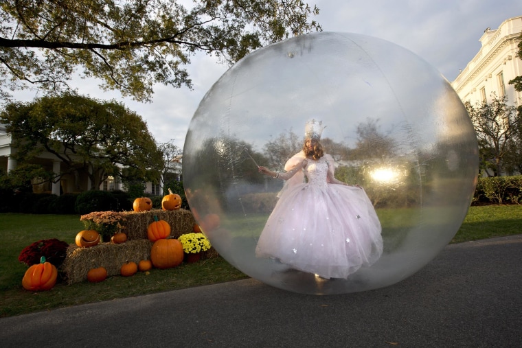 A actress dressed as Glinda, the Good Witch of the North from the Movie 'The Wizard of Oz,' performs by the Rose Garden of the White House before President Barack Obama greeted costumed children during Halloween festivities at the White House in Washington, on Oct. 31. President Barack Obama and first lady Michelle Obama welcomed local children and children of military families to 'trick-or-treat' at the White House for Halloween.