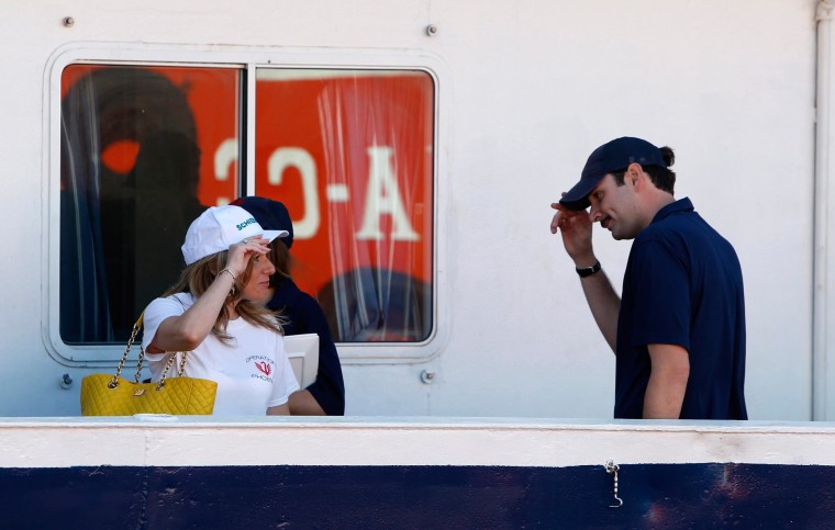 Image: Regina Catrambone bids farewell to her husband Christopher on board the Phoenix