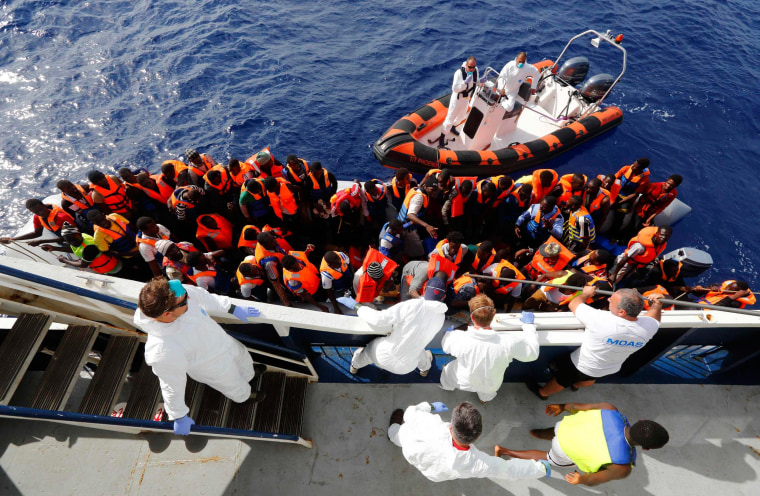 Image: Handout photo shows migrants boarding the Phoenix on Oct. 4