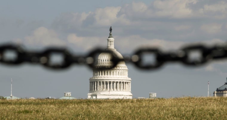 Image: File photo of the U.S. Capitol pictured behind a chain link fence in Washington