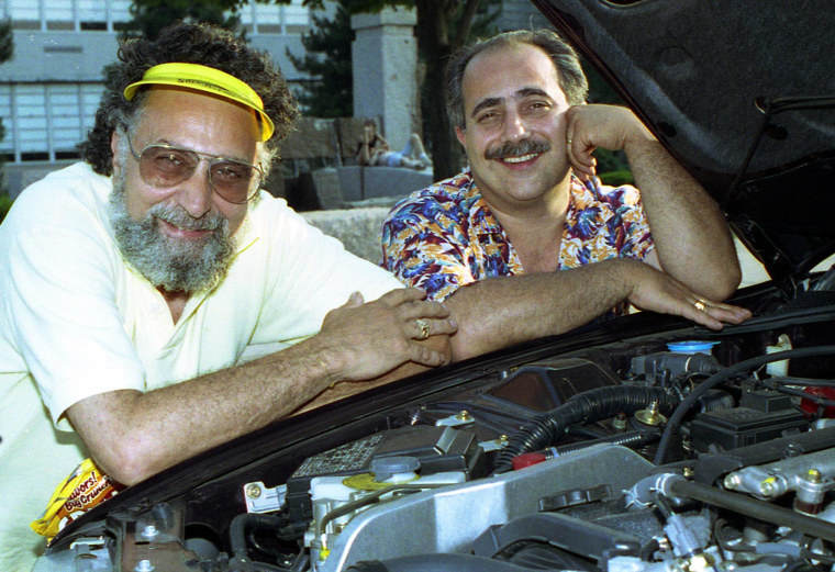 Image: Brothers Tom, left, and Ray Magliozzi pose under a car hood in Boston on July 9, 1991.