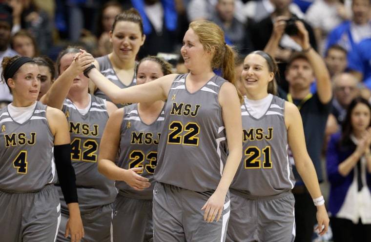 Lauren Hill of Mount St. Joseph celebrates with her teammates after the game against Hiram at Cintas Center on Nov. 2, in Cincinnati, Ohio. Hill, a freshman, has terminal cancer and this game was granted a special waiver by the NCAA to start the season early so she could play in a game. 