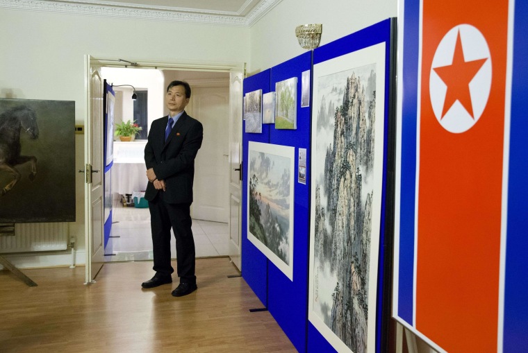 Image: A staff member supervises during a photocall at the North Korean Embassy in London