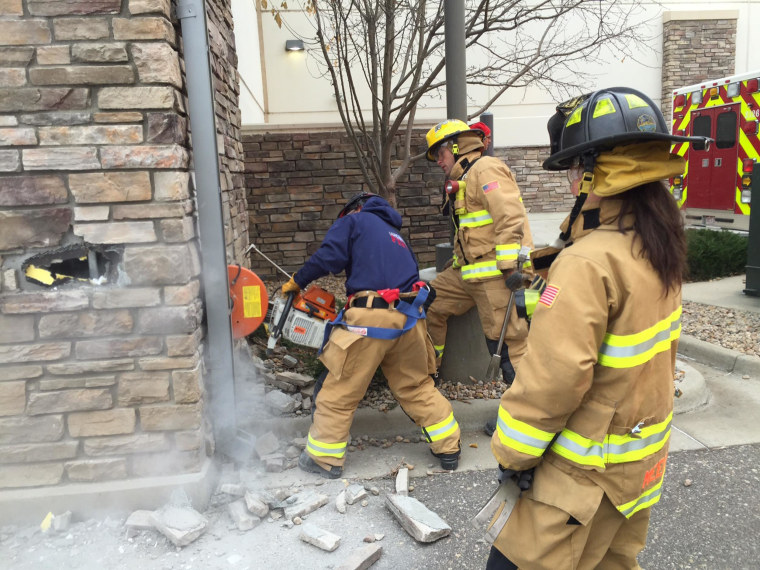 Image: Firefighters rescued a man from the wall of a Marshall's store in Longmont, Colorado