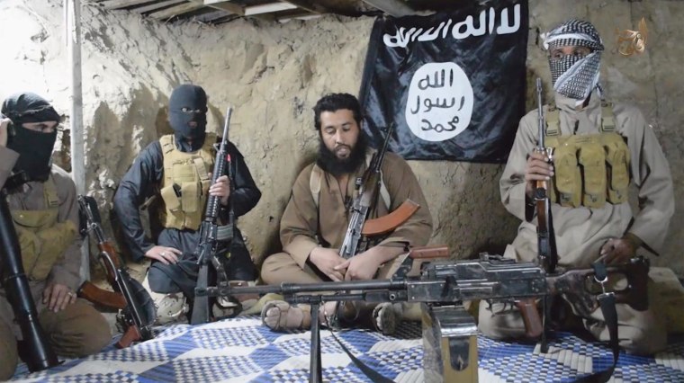 Image: ISIS fighters sit in a cave.