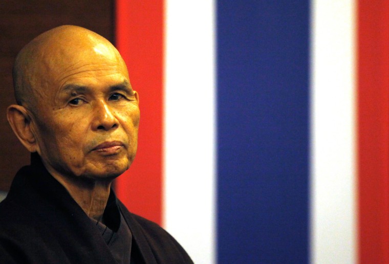 Image: French-based Buddhist zen master Thich Nhat Hanh gestures during his arrival at Suvarnabhumi airport in Bangkok