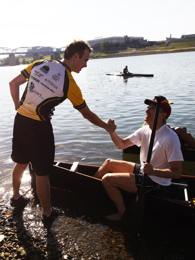 Image: U.S. Sen. Rob Portman is greeted by his son Will, 20 after finishing the annual Cincinnati event, Paddlefest
