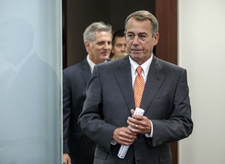 House Speaker John Boehner of Ohio, followed by House Majority Leader Kevin McCarthy of Calif., left, and others, emerge from a House GOP caucus meeting on Capitol Hill in Washington, Tuesday, Nov. 18, 2014.  (AP Photo/J. Scott Applewhite)