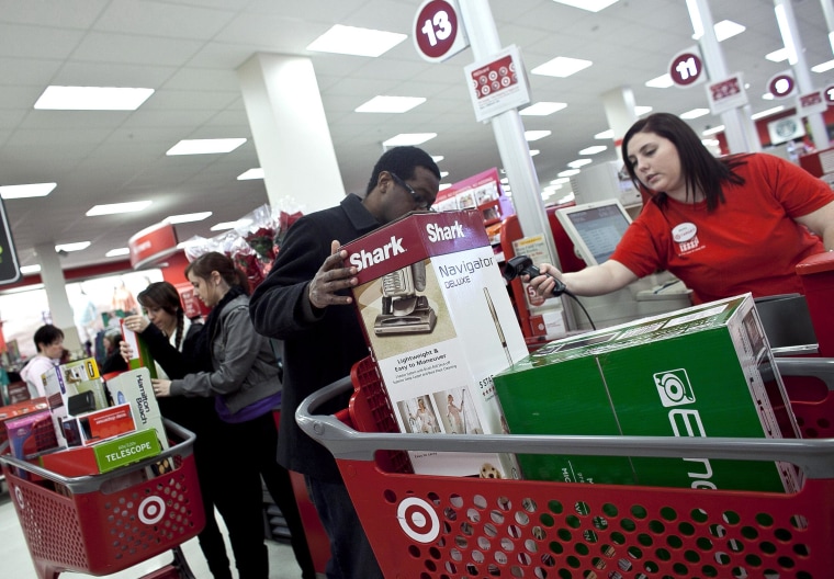 Shoppers check out during Black Friday sales at a Target store in Braintree, Massachusetts, on Nov. 23, 2012.