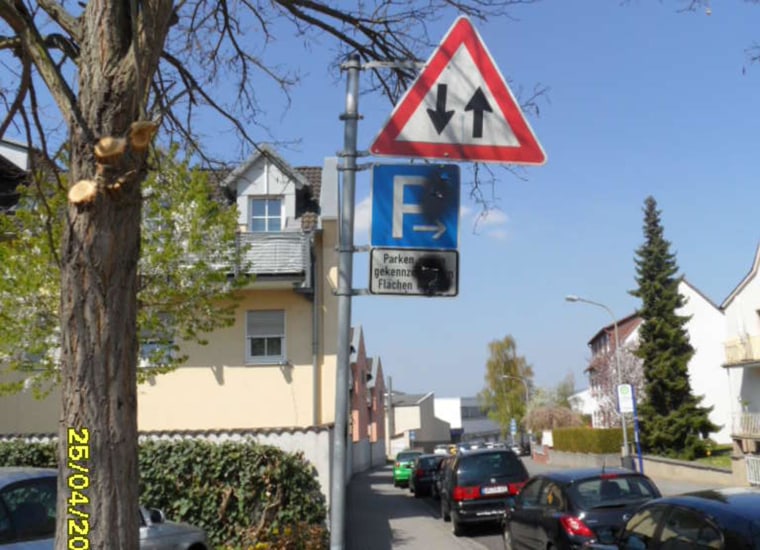 Image: Spray paint covers neo-Nazi graffiti on street signs in Limburg, Germany