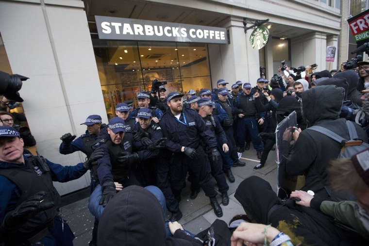 Image: Protesters clash with police outside London Starbucks