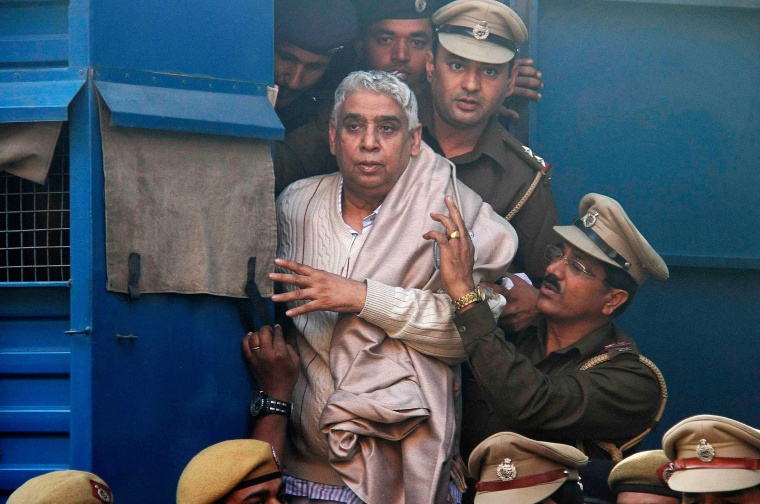 Image: Satguru Rampalji Maharaj, a self-styled \"godman\" is escorted to the high court after his arrest, in Chandigarh