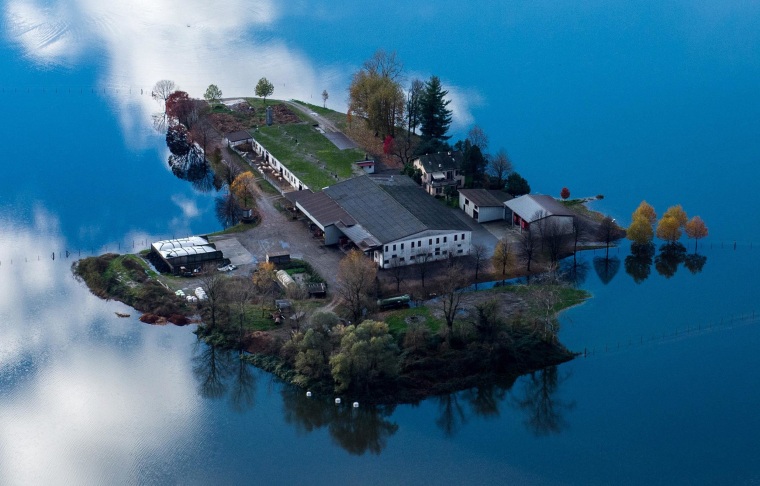 Image: Floodwaters caused by heavy rains surround a farm near the village of Magadino in Ticino, Switzerland