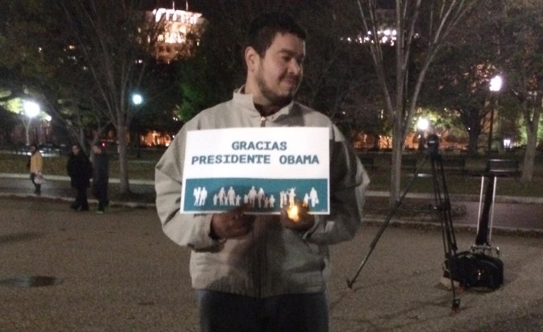 Image: A demonstrator holds a sign reading "Thank you President Obama" outside the White House