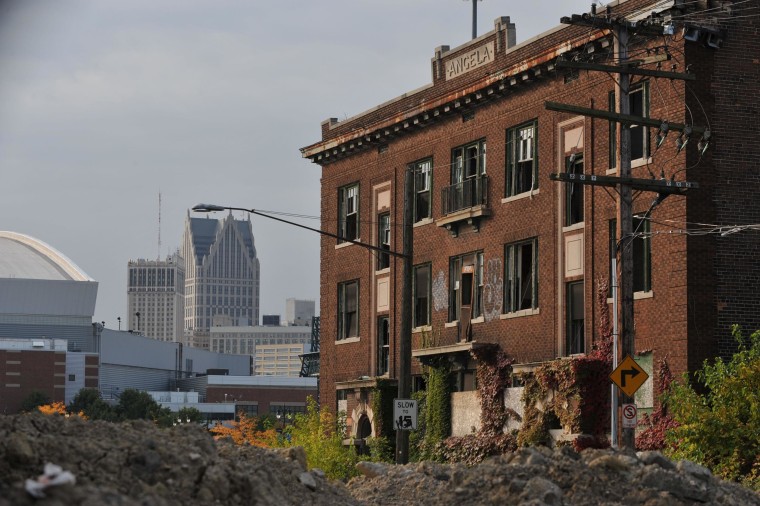 Image: Ford Field, home of the Detroit Lions, is seen near an abandoned building in September 2013.