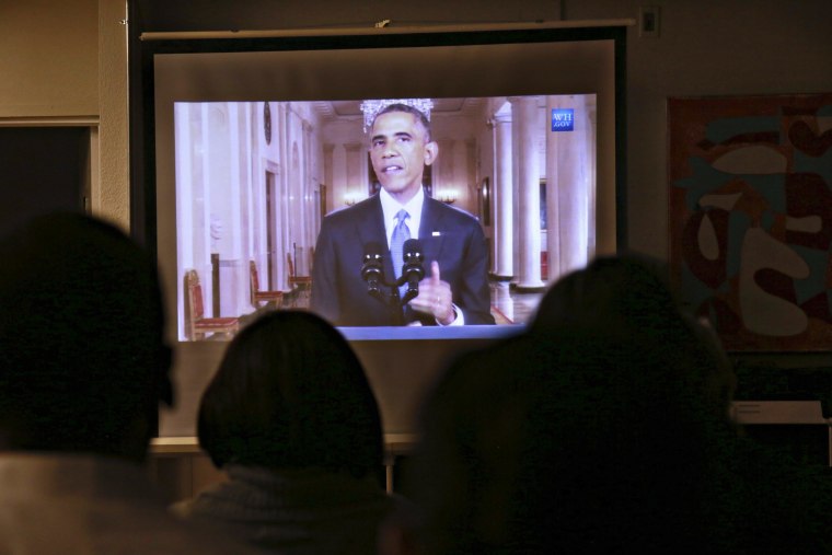 Image: Guests watch President Barack Obama's White House speech on immigration in San Diego
