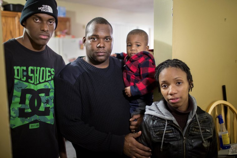 Image:Police officer Robert Howard with his two sons and wife Jamie. The family lives in Ferguson, Missouri, near the site where Michael Brown was shot and killed by police officer Darren Wilson.
