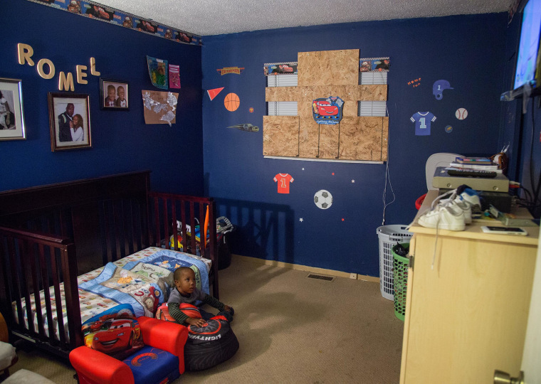 Image: Two-year-old Romel Howard watches TV in bedroom of his family's  Hillsdale, Missouri home.