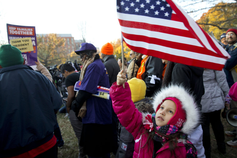 Image: Joselyn Vargas, 7, of Hyattsville, Md., waves a U.S. flag during a rally across from the White House
