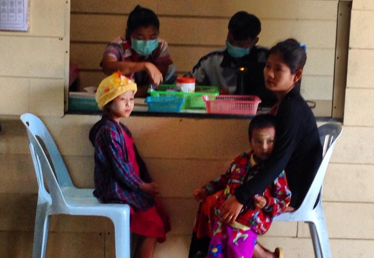 A Karen woman and her children wait for a blood test at the Wang Pha clinic.