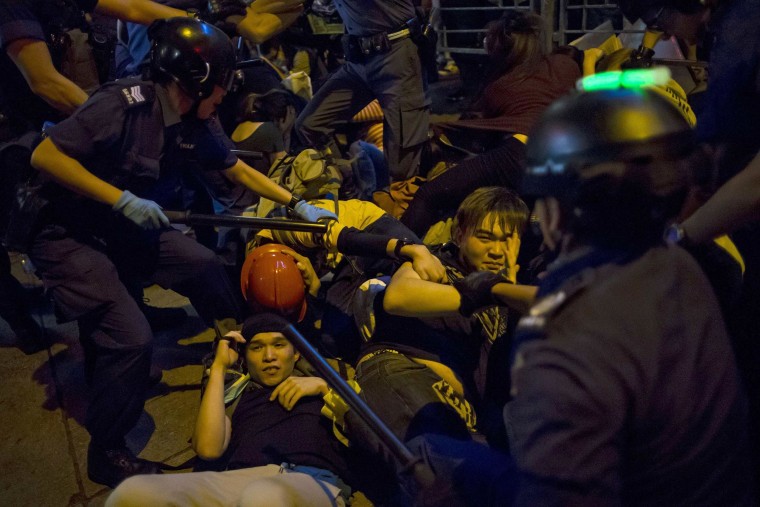 Image: Pro-democracy protesters fall on the ground as they are chased by riot police at Mong Kok shopping district in Hong Kong