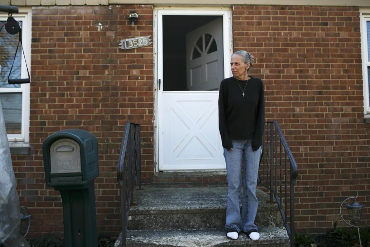 Image: Donna Cox stands outside of her home in Cleveland, OH