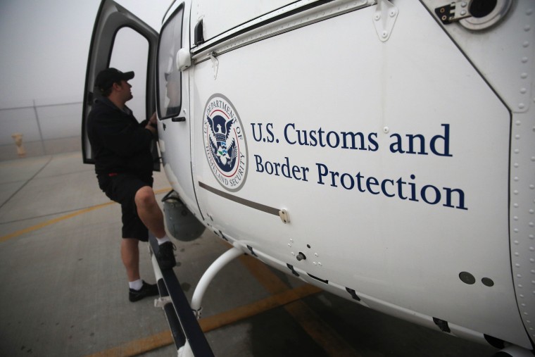 A maintenance worker prepares a U.S. Office of Air and Marine (OAM) helicopter for takeoff to patrol the U.S.-Mexico border on October 1, 2013 in San Diego, California. OAM helicopters support the U.S. Border Patrol as well as Immigration and Customs Enforcement (ICE), personnel protecting border areas. While much of the Federal Government has closed down, personnel considered essential, such as border agents, remain working. 