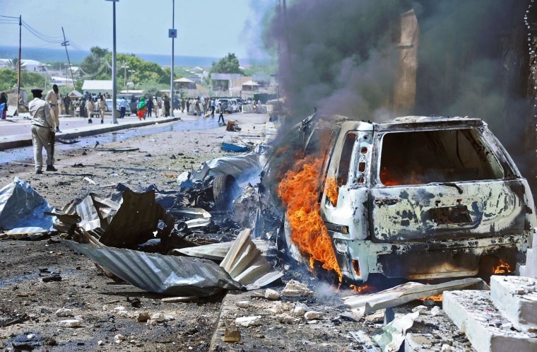 Image: A car burns following a blast in Mogadishu