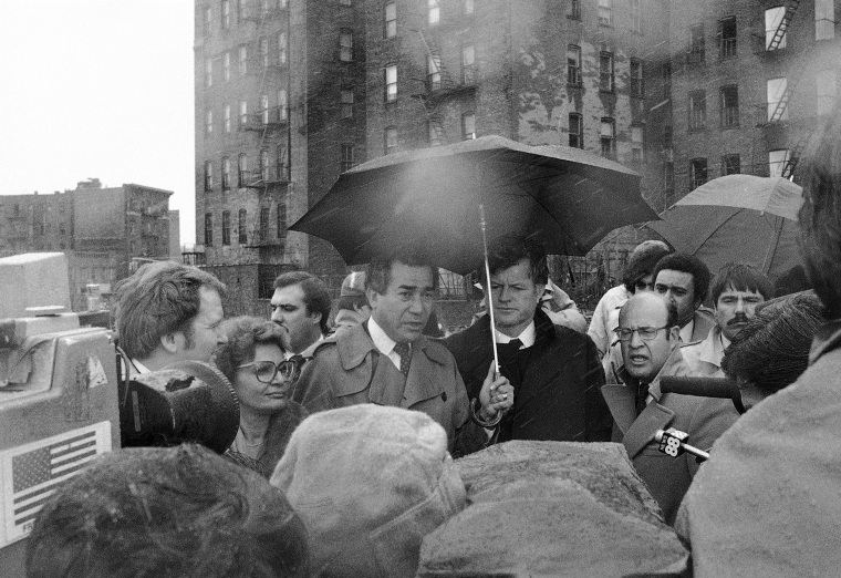 Herman Badillo, center left, stands in cold, driving rain with Sen. Edward Kennedy on March 22, 1980 at the same place in the South Bronx where President Jimmy Carter stood three years ago and said "Get me a map of the whole area and show me what should be done." Kennedy said Carter had failed to deliver on his promises to the area.