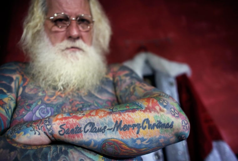 Image: Vitor Martins displays one of his Christmas tattoos inside his house near Sao Paulo