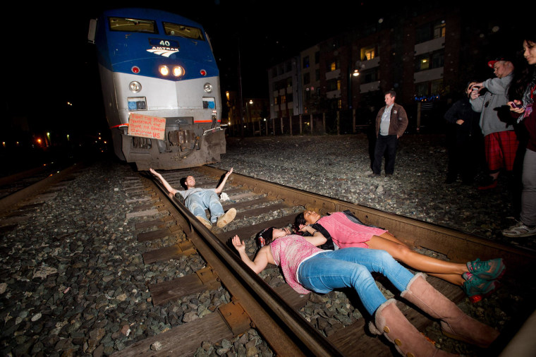 Image: Protesters block an Amtrak train in Berkeley