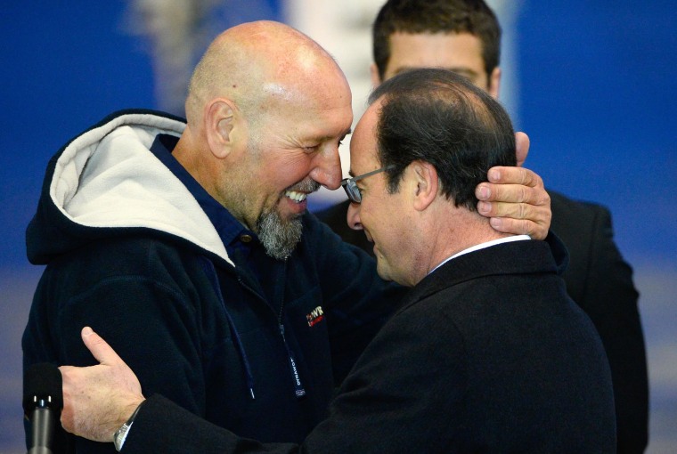 Image: Serge Lazarevic, left, France's last remaining hostage, embraces French President Francois Hollande