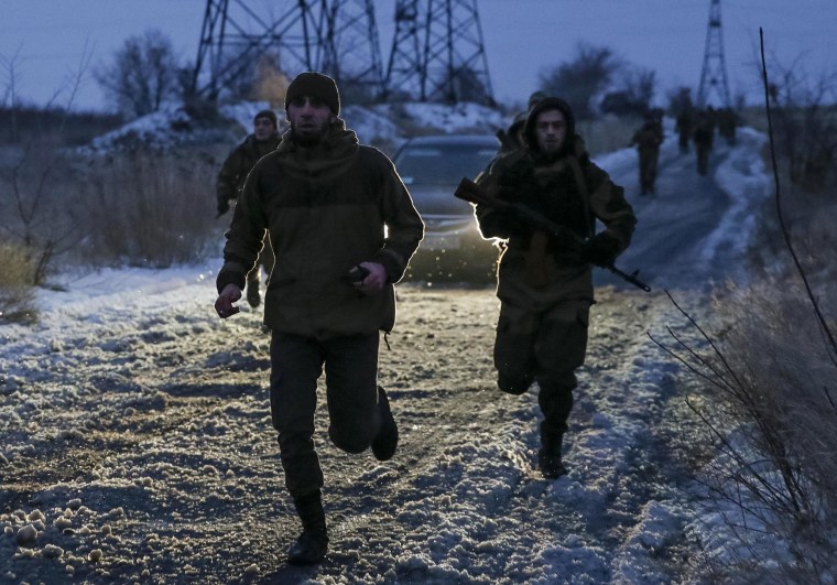 Image: Pro-Russian separatists from the Chechen \"Death\" battalion run during a training exercise in the territory controlled by the self-proclaimed Donetsk People's Republic