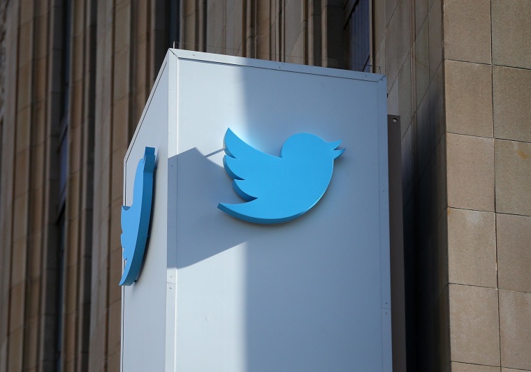 The Twitter logo hangs outside company headquarters in San Francisco.