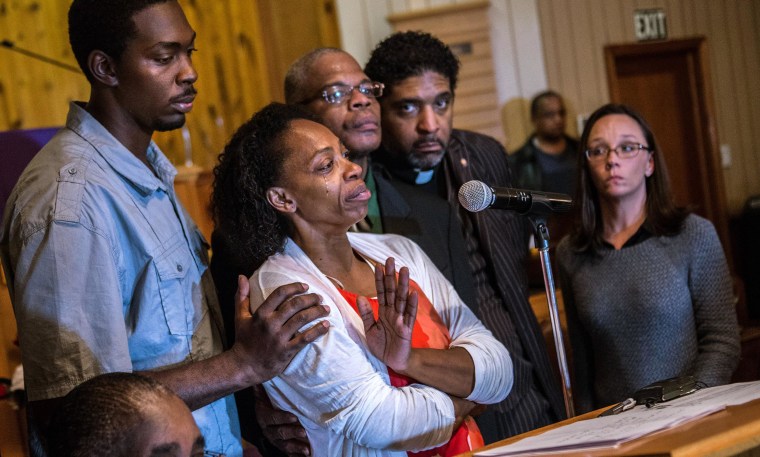 Image:  Claudia Lacy, center, cries as she thanks the people that showed up at First Baptist Church in Bladenboro, N.C., to listen to the Rev. Dr. William Barber II, president of the North Carolina State Conference of the NAACP, talk about the development