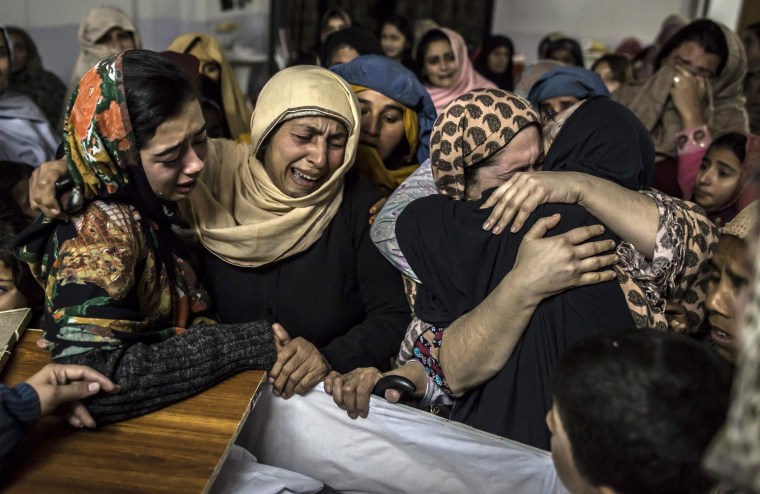 Image: Women mourn their relative Mohammed Ali Khan, a student who was killed during an attack by Taliban gunmen on the Army Public School, at his house in Peshawar
