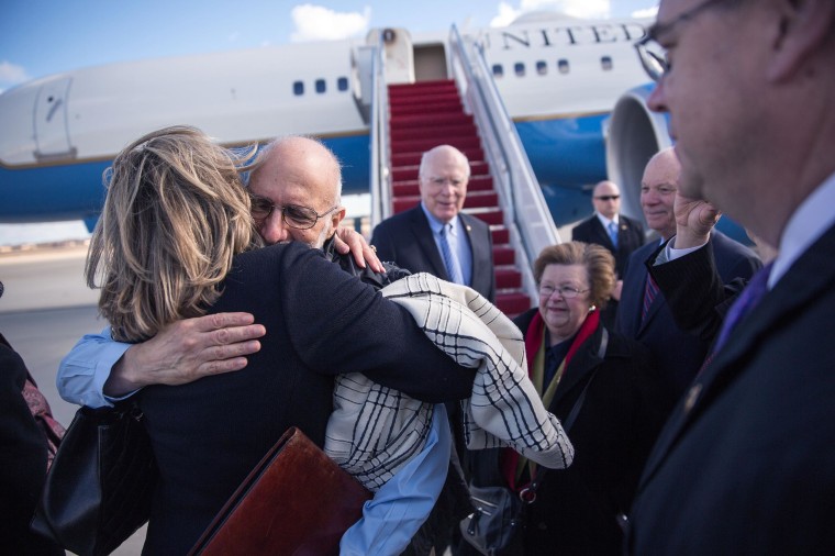 Alan Gross is greeted with hugs after arriving at Joint Base Andrews, Md., Dec. 17, 2014. Gross spent 5 years as a prisoner in Cuba.House.