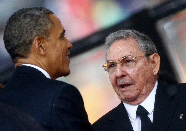 Image: File photo of U.S. President Obama greeting Cuban President Castro at the memorial service for Mandela in Johannesburg