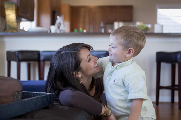 Two year old, Maddox Coursen Van Dorn, with his mother Nicole in the family's living room in Virginia Beach, Virginia, Nov. 2014. Maddox's father, Lt. J Wesley Van Dorn, was killed in a MH-53E Sea Dragon helicopter crash in January 2014.