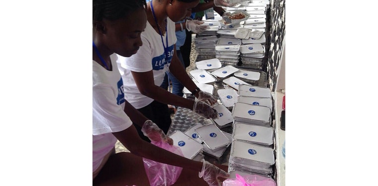 Volunteers pack meals for LunchBoxGift