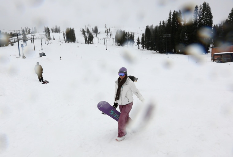 Image: Katie McGlothern, 25, leaves the slopes as rain begins to fall at the Boreal Mountain Ski Resort