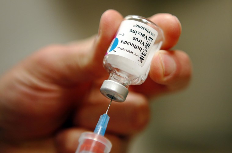 A nurse prepares an injection of the influenza vaccine at Massachusetts General Hospital in Boston, Massachusetts