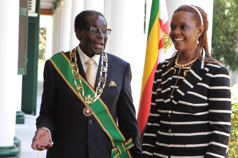 Zimbabwe President Robert Mugabe stands with his wife Grace