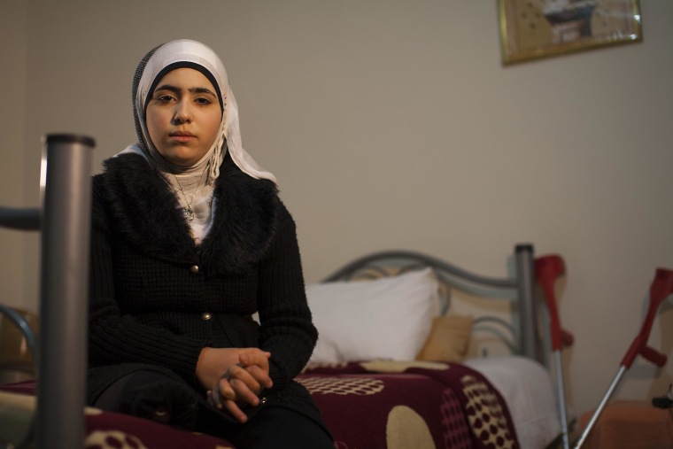 Noor sits in the hotel room she shares with her mother in Reyhanli, southern Turkey.