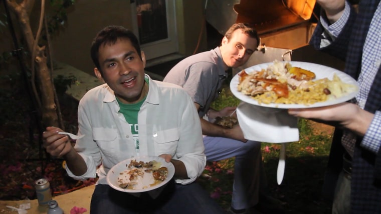 Image: A party-goer enjoys the slow-roasted pork.