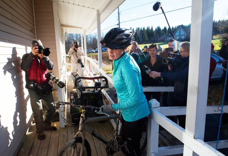 Image: Kaci Hickox returns to her home surrounded by media after going for a bike ride with boyfriend Ted Wilbur in Fort Kent