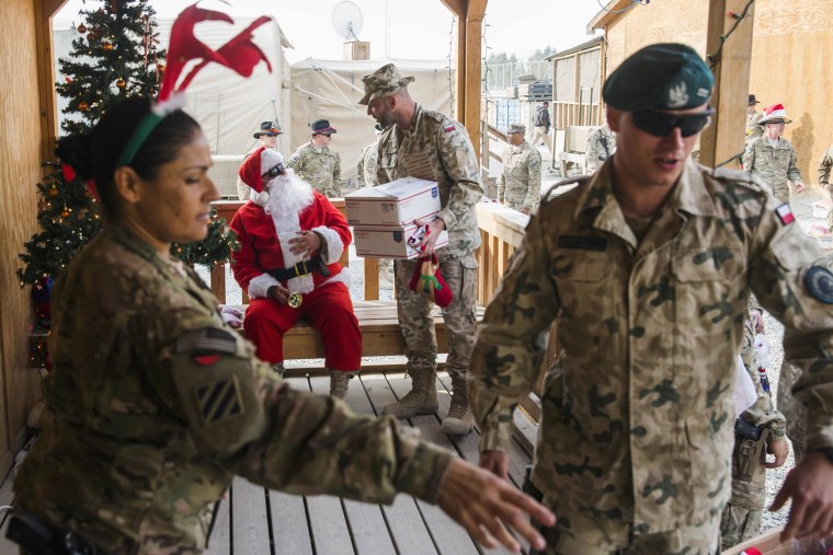 Image: U.S. soldiers from the 3rd Cavalry Regiment pass out care packages and Christmas stockings to fellow soldiers and workers on forward operating base Gamberi in the Laghman province of Afghanistan