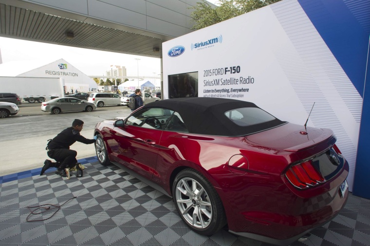 Image: Daniel Cervantes of Detail Werks cleans a 2015 Ford Mustang in preparation for the 2015 International Consumer Electronics Show (CES) at Las Vegas Convention Center in Las Vegas