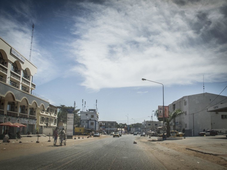 Image: Residents walk on an empty street in Banjul Gambia, Tuesday, Dec. 30, 2014.